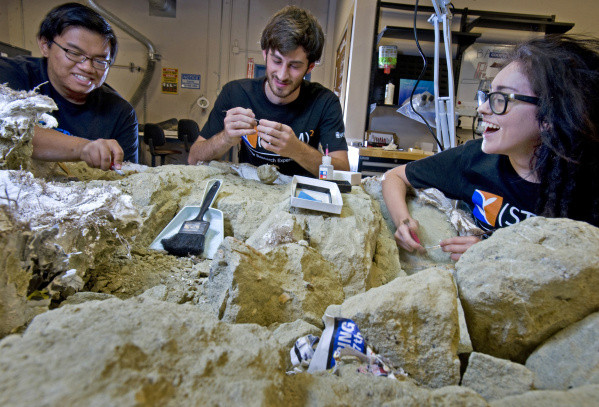 Left to right, aspiring paleontologists Gabriel Santos, Daniel Weiherer and Roseanna Garcia work at the John D. Cooper Center Archaeology Lab in Santa Ana.