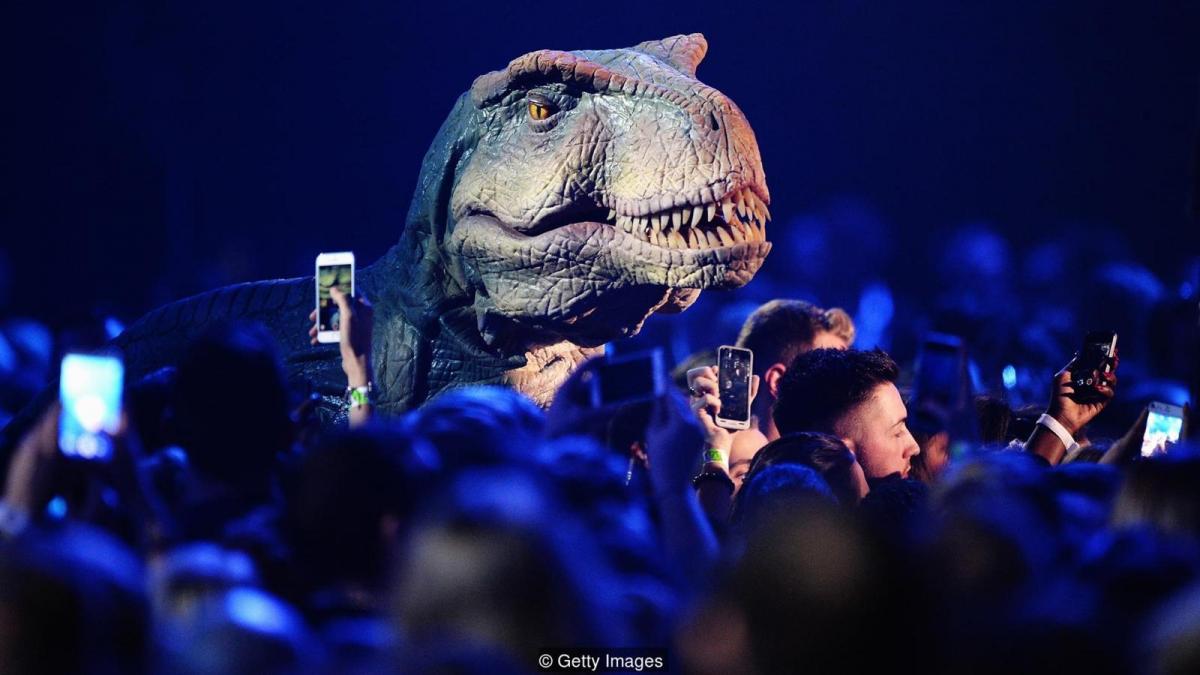 Model dinosaur surrounded by people (Credit: Getty Images)