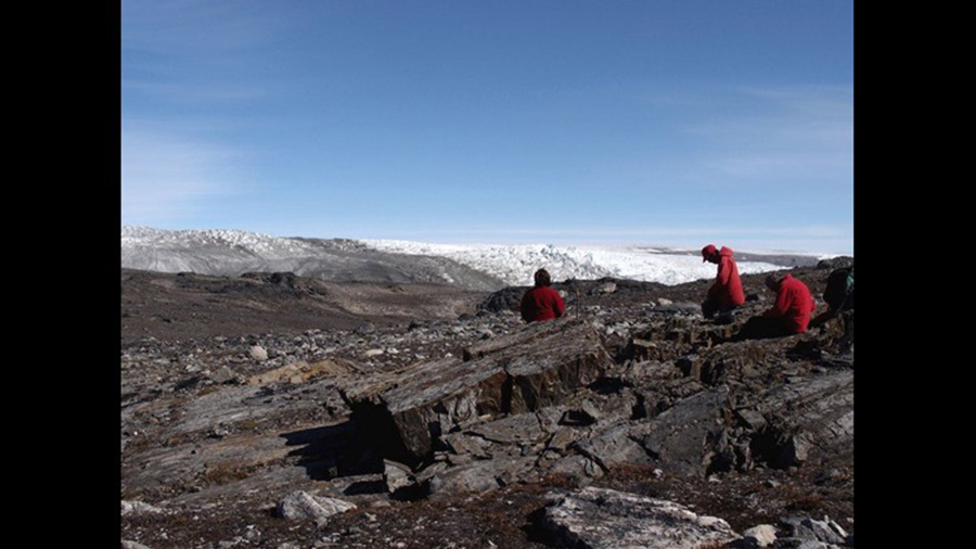 In this July 2012 photo provided by Laure Gauthiez, scientists Vickie Bennett, Allen Nutman and Clark Friend examine rocks in Greenland. A new study says what were billed as the oldest fossils on Earth may just be some rocks. Two years ago, a team of Australian scientists, including Nutman, found odd structures in Greenland that they said were partly a leftover from microbes that lived on an ancient seafloor. The tiny structures were said to be 3.7 billion years old. But different researchers concluded in a study published Wednesday, Oct. 17, 2018, that the structures were likely not fossils. The Australian scientists defended their work. Laure Gauthiez/The Australian National University via AP, File