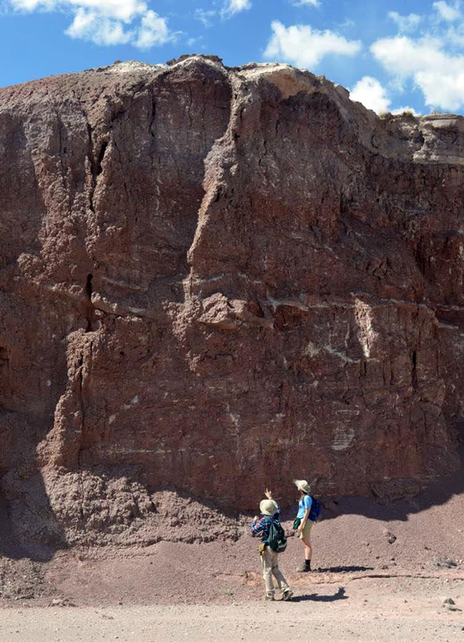 URI graduate student Reilly Hayes (left) and undergraduate Amanda Bednarick examine an outcrop for fossils at Petrified Forest National Park as part of their research. Credit: Photo courtesy of Amanda Bednarick)